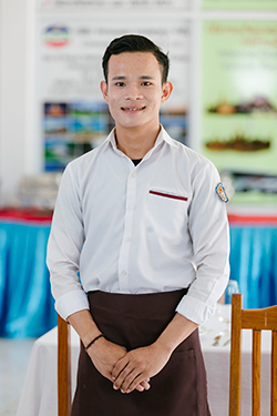 F& student Vilaxay Xaimonthy posing in his waiter outfit