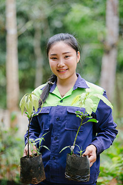 DCT farming student holding two plants